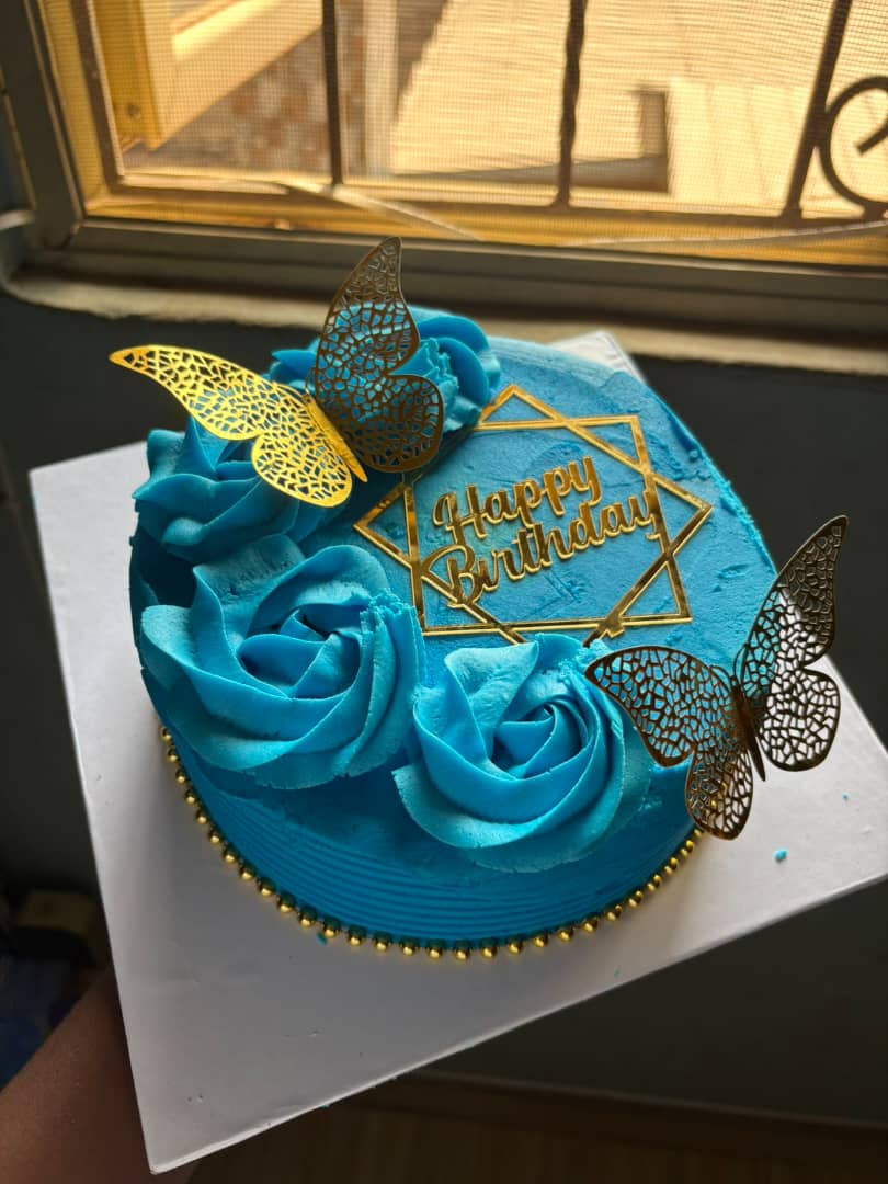 Blue rosette birthday cake with gold butterflies